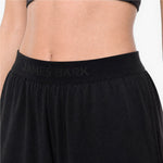 Black athletic pants with 'James Bark' branding on a neutral background