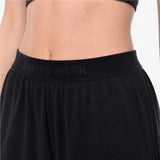 Black athletic pants with 'James Bark' branding on a neutral background