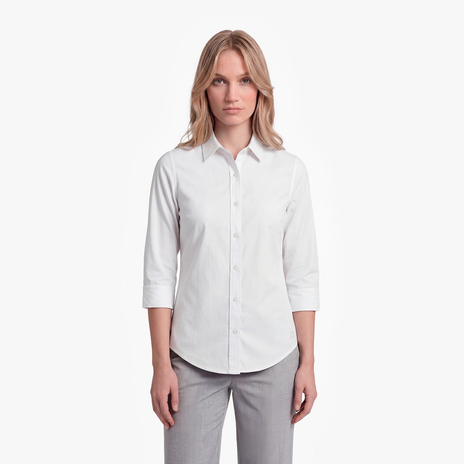 Woman wearing a white shirt and gray pants on a white background