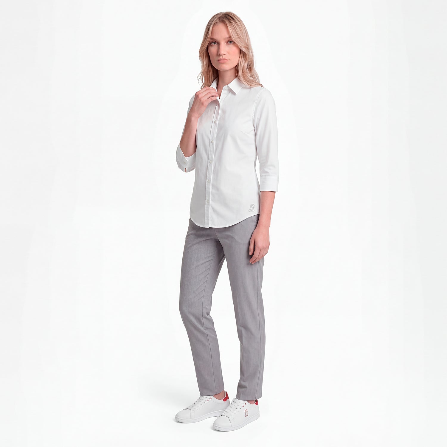 Woman wearing a white shirt and gray pants on a white background