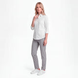 Woman wearing a white shirt and gray pants on a white background