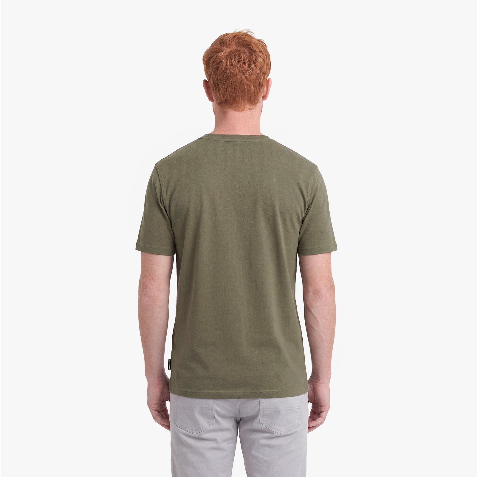 Back view of a man wearing a green t-shirt on a white background