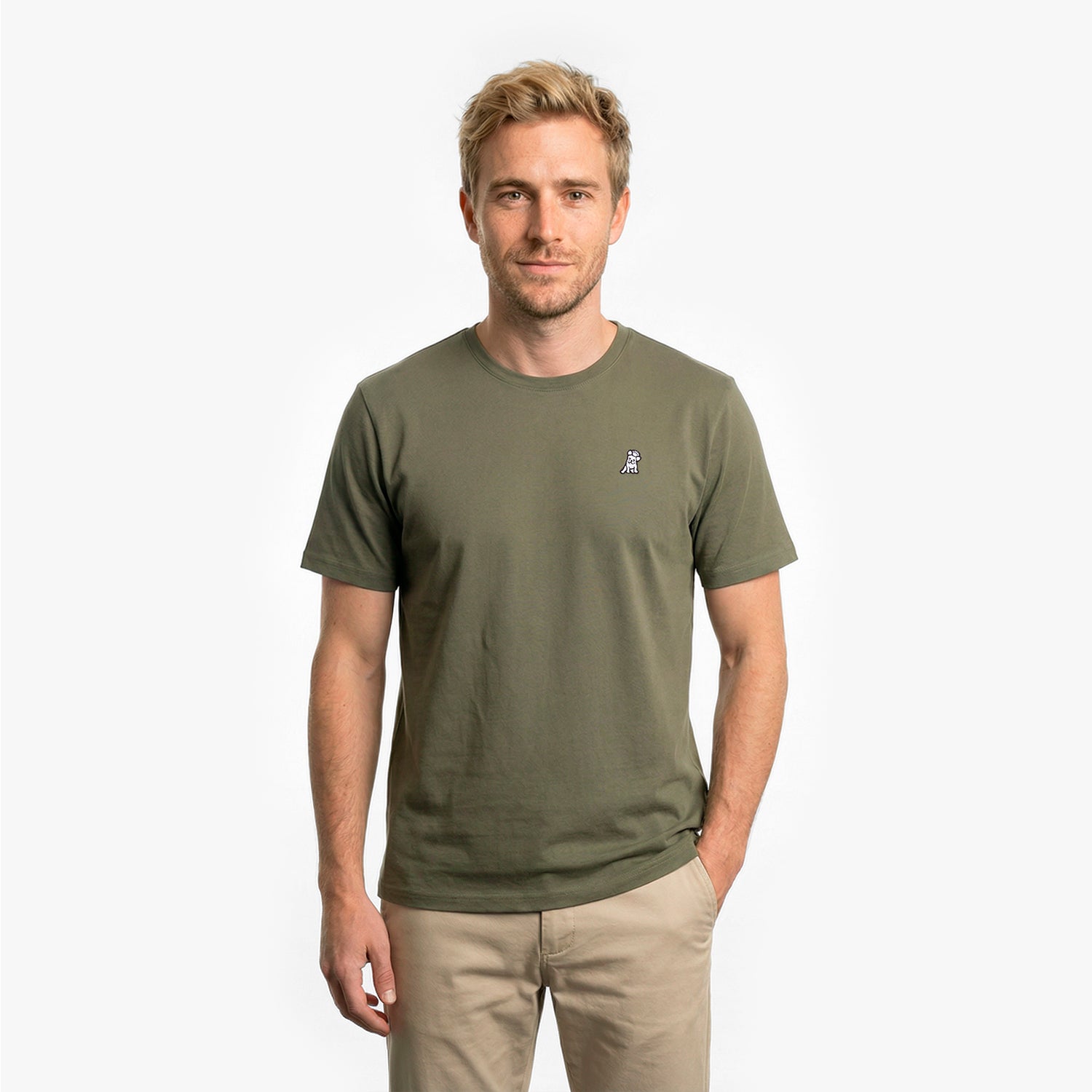 Man wearing a green t-shirt with a small logo on a white background