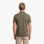 Back view of a man wearing a green polo shirt on a white background