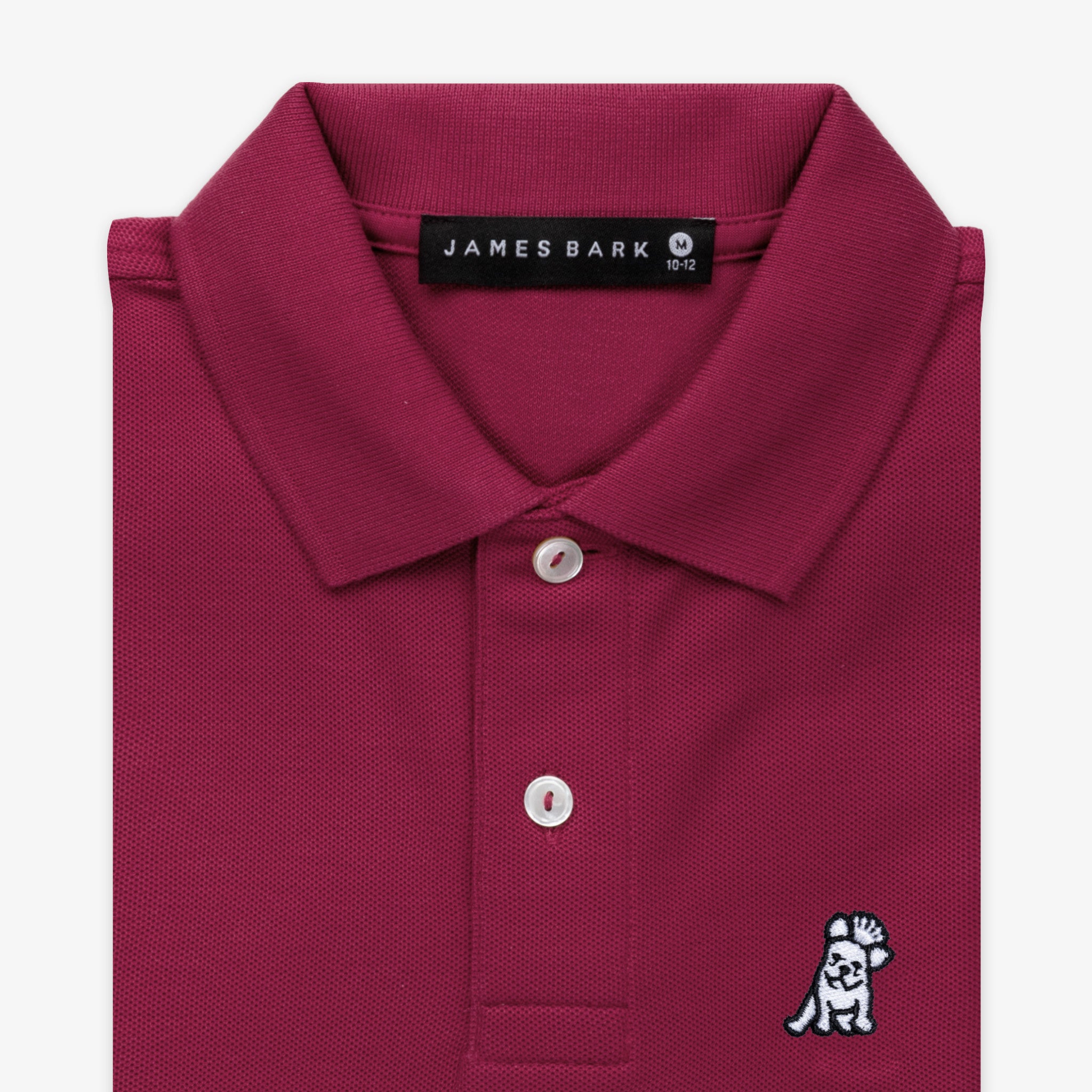 Close-up of the collar and chest area of the burgundy polo shirt, showing the button placket and embroidered logo.