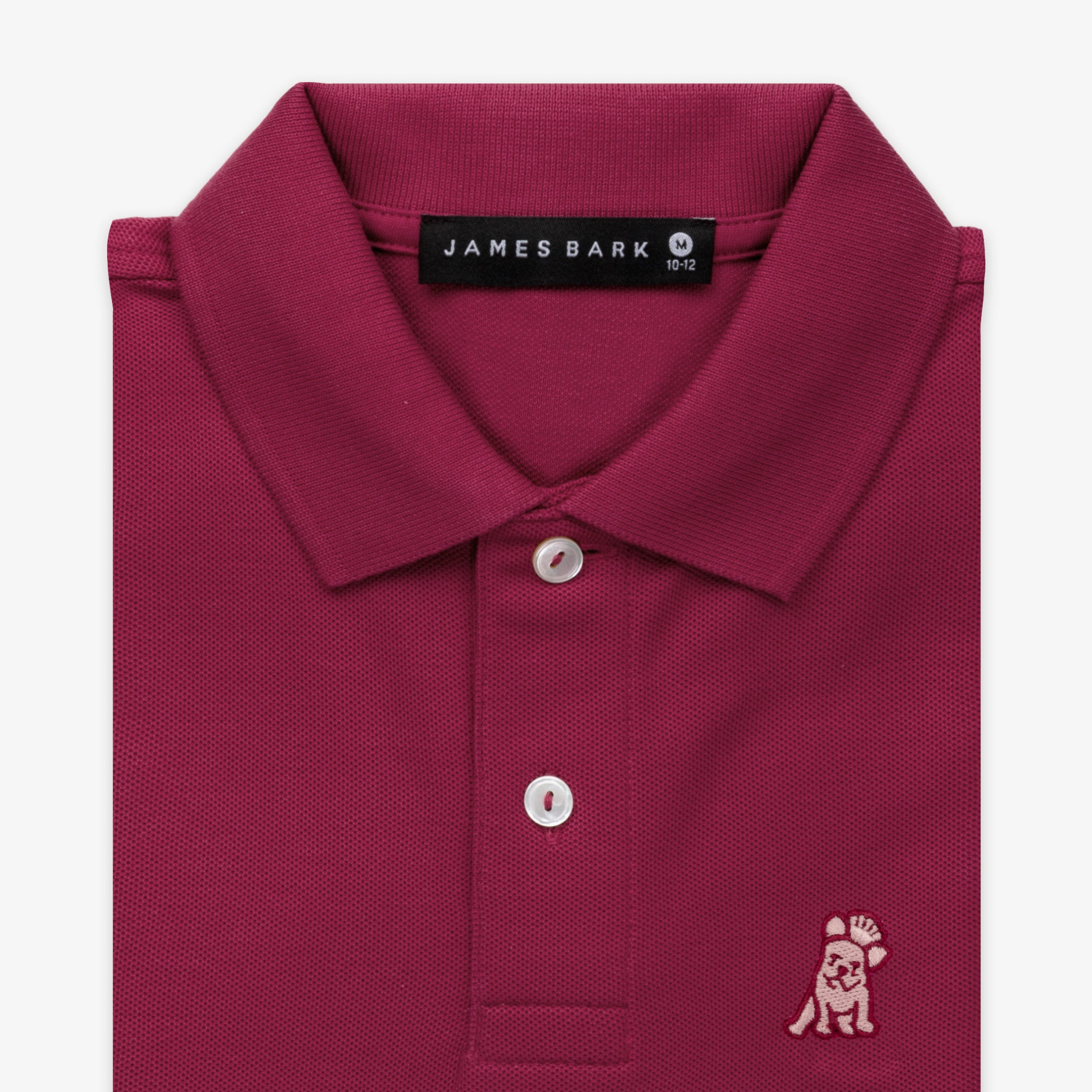 Close-up of the collar and chest area of the burgundy polo shirt, showing the button placket and the small embroidered logo.