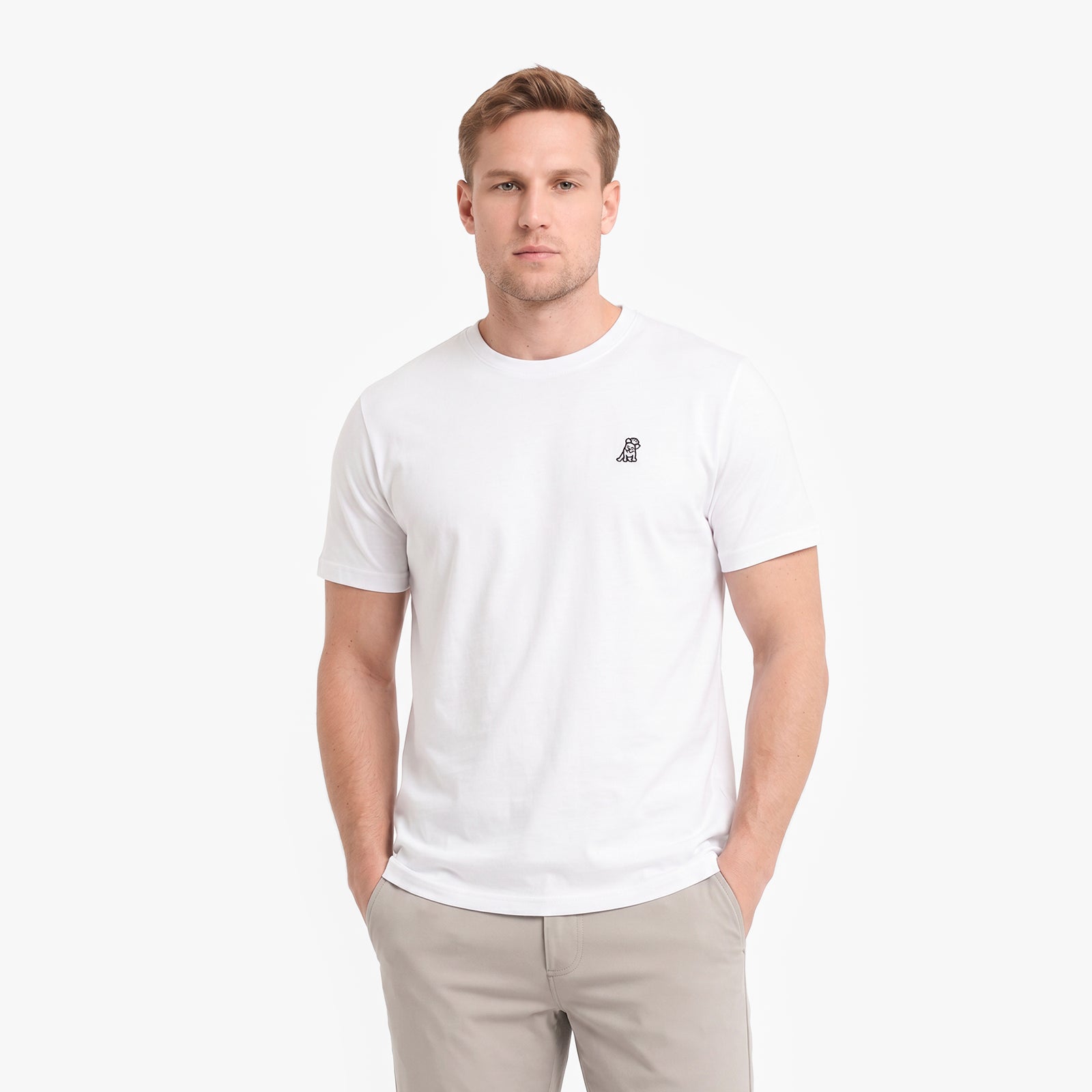A man wearing a white short-sleeve crewneck t-shirt with a small black embroidered logo