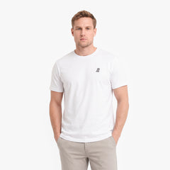 A man wearing a white short-sleeve crewneck t-shirt with a small black embroidered logo