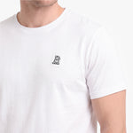 A close-up of a person wearing a white short-sleeve crewneck t-shirt