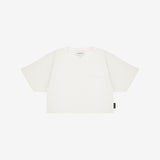 A white crop top t-shirt with a small tonal logo on the left chest and a small black brand tag on the lower hem