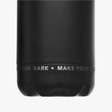 Close-up view of the bottom part of the black water bottle, featuring the text 'MAKE YOUR MARK' printed in white.