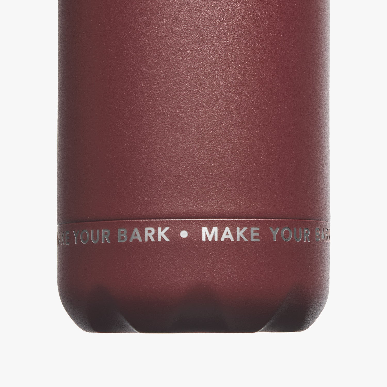 Close-up view of the bottom part of the maroon water bottle, showcasing the text 'MAKE YOUR MARK' printed in white.