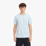 Person wearing a light blue t-shirt on a white background