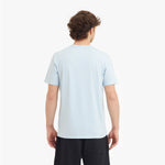 Person wearing a light blue t-shirt on a white background