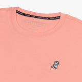 Close-up of the collar and inner label of the light pink t-shirt, showing the brand information and neck design.