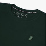 Close-up of the collar and inner label of the dark green t-shirt, showing the brand information and neck design.