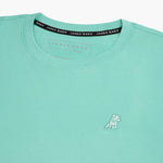 Close-up of the collar and inner label of the mint green t-shirt, showing the brand information and neck design.