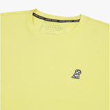 Close-up of the collar and inner label of the light yellow t-shirt, showing the brand information and neck design.