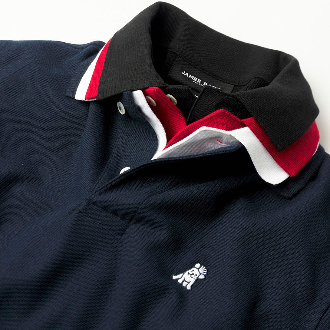 Close-up of a black polo with red and white accents on a white background
