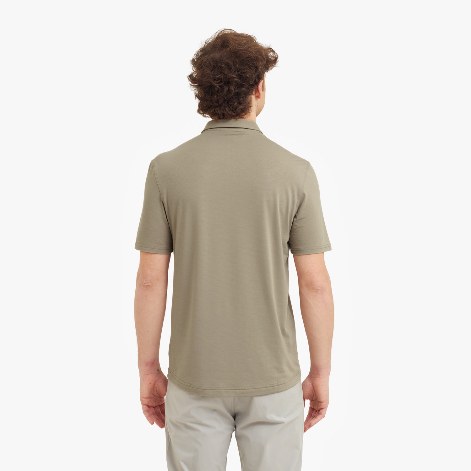Man wearing a beige polo shirt on a white background