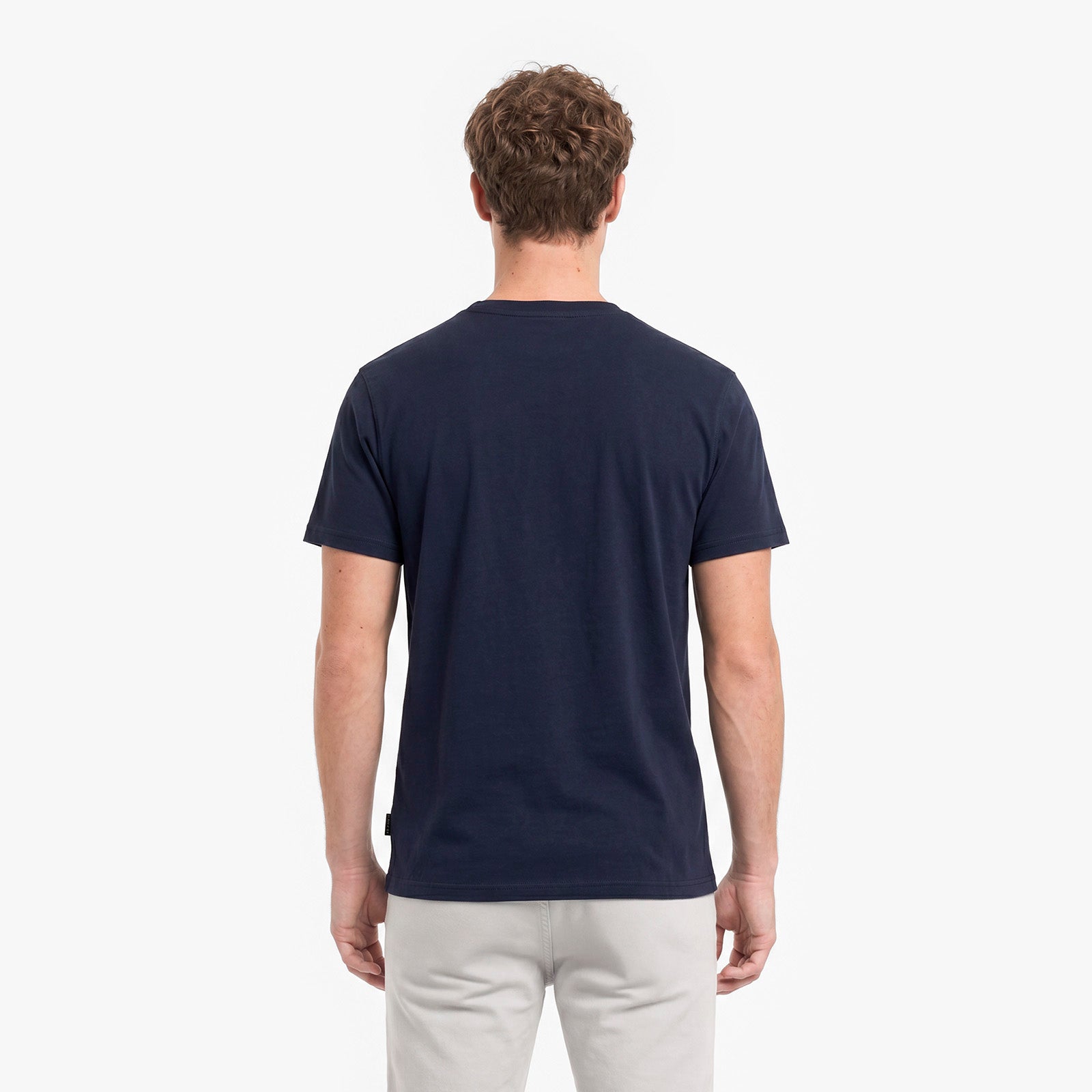 Man wearing a navy blue t-shirt on a white background