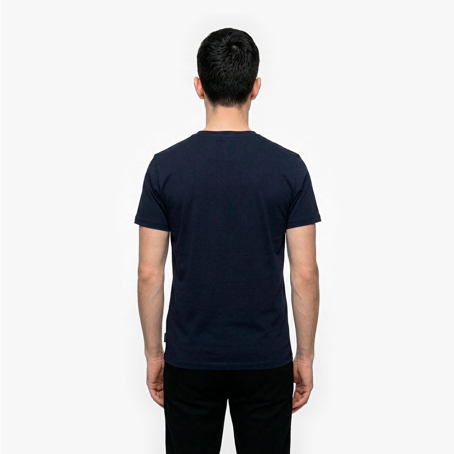 Back view of a man wearing a navy blue t-shirt on a white background