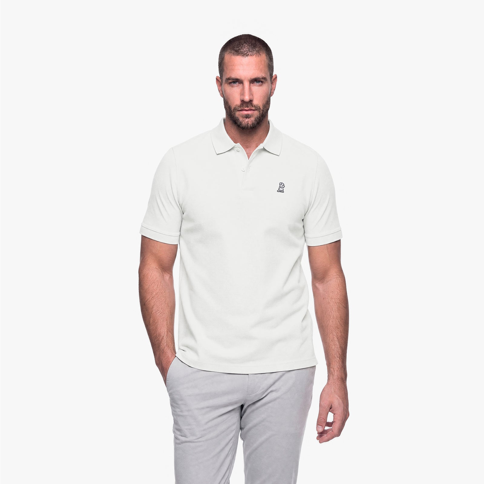 Man wearing a white polo with a white embroidered logo on a white background