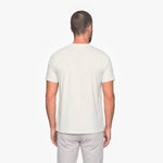 Man wearing a plain white t-shirt on a white background