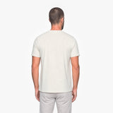 Man wearing a plain white t-shirt on a white background