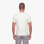 Man wearing a plain white t-shirt on a white background