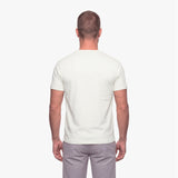 Man wearing a plain white t-shirt on a white background