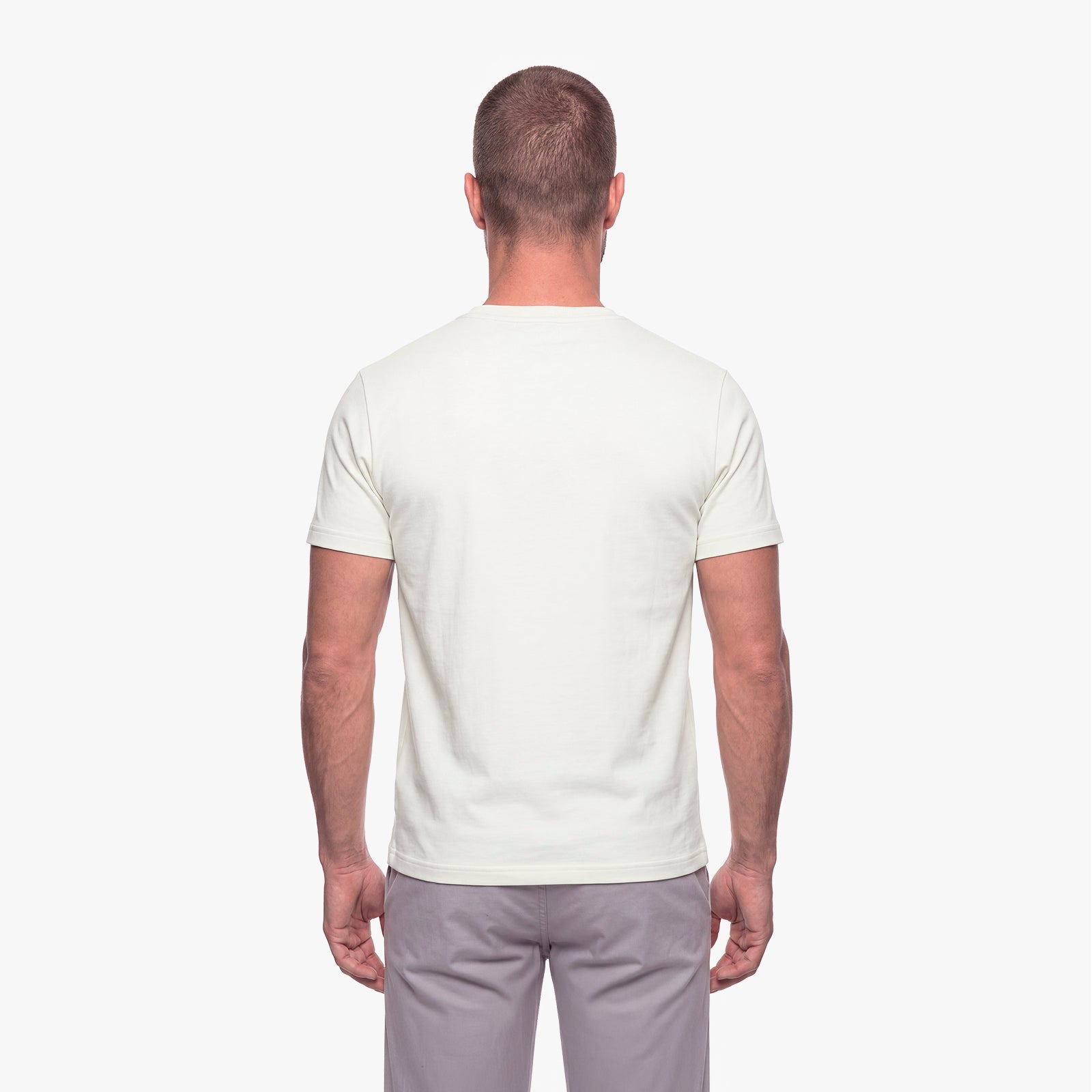 Man wearing a plain white t-shirt on a white background
