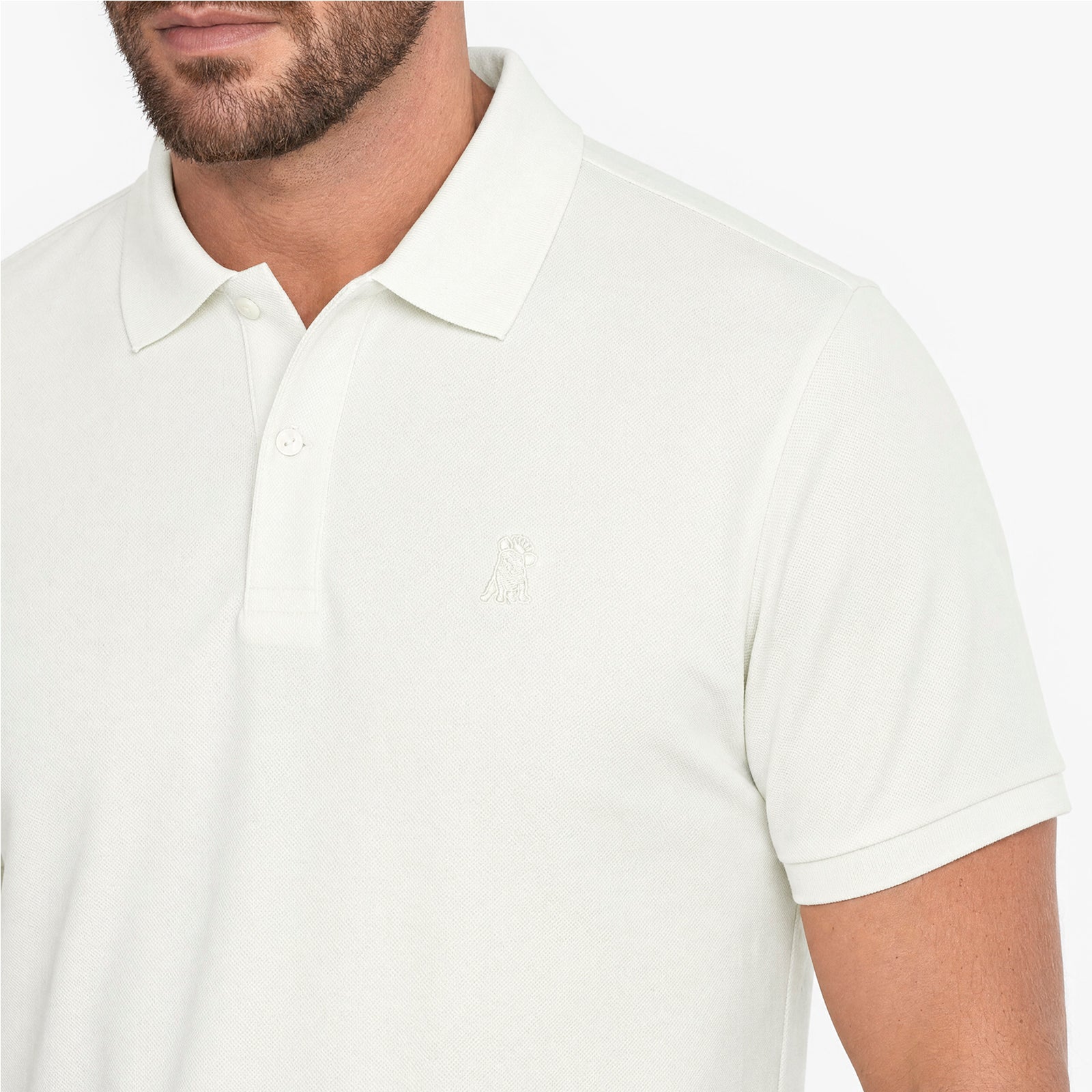 White polo shirt worn by a person on a white background