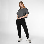 Full-length shot of a woman modeling a grey James Bark Elements cropped t-shirt and black joggers.