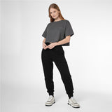Full-length shot of a woman modeling a grey James Bark Elements cropped t-shirt and black joggers.