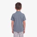 Back view of a boy wearing a slate blue polo shirt