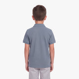Back view of a boy wearing a slate blue polo shirt