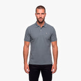 Man wearing a gray polo with a white embroidered logo on a white background