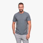 Man wearing a gray t-shirt with a small logo on a white background