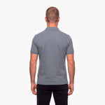 Man wearing a gray polo shirt on a white background