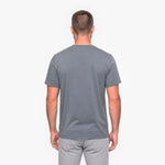 Back view of a man wearing a gray t-shirt on a white background