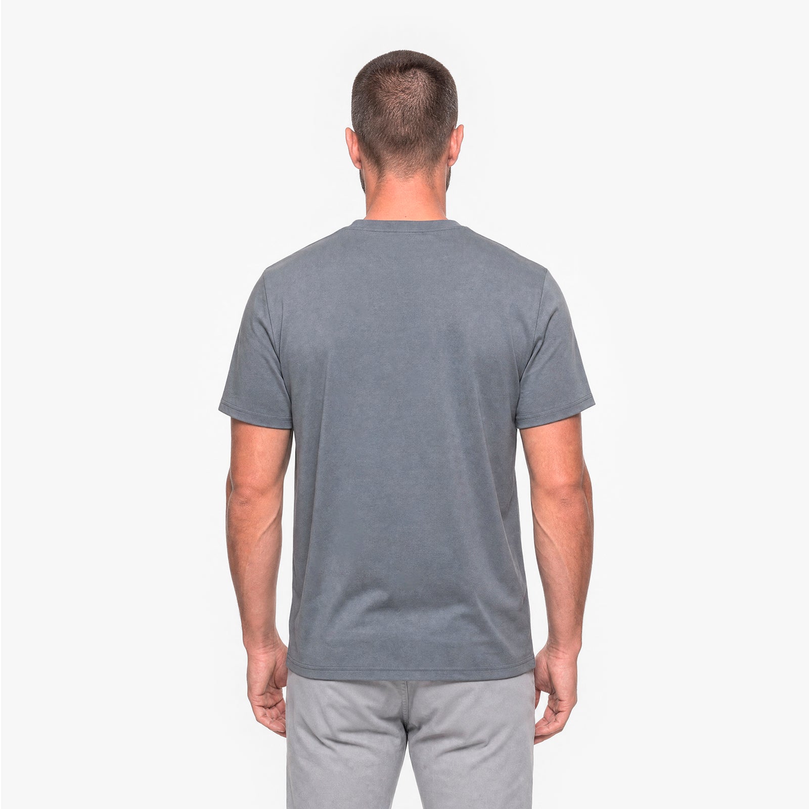 Back view of a man wearing a gray t-shirt on a white background