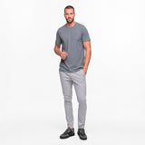 Man wearing a gray t-shirt and pants on a white background