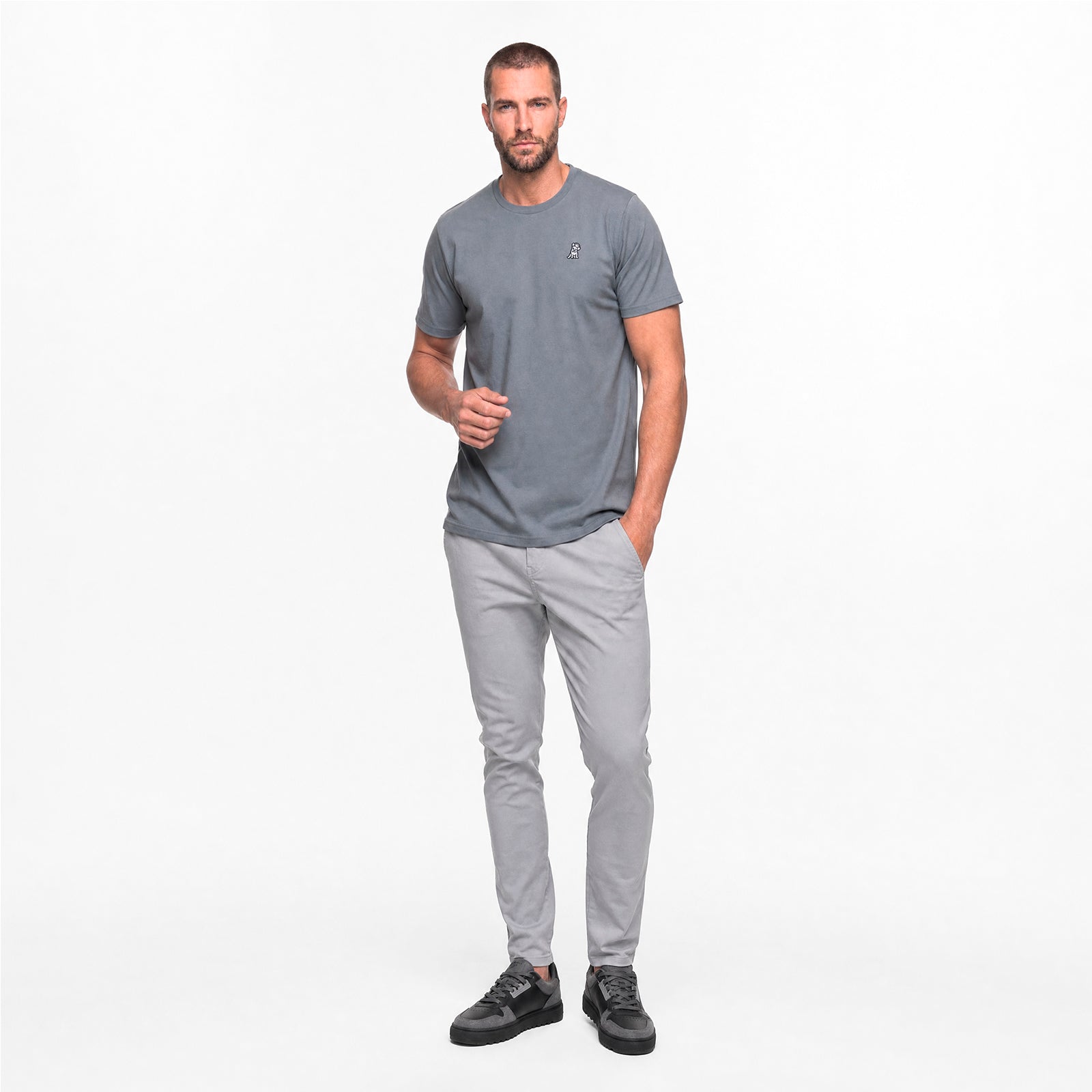 Man wearing a gray t-shirt and pants on a white background