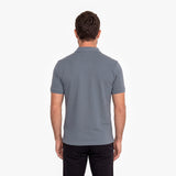 Back view of a man wearing a gray polo