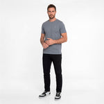 Man wearing a gray t-shirt and black pants on a white background