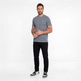 Man wearing a gray t-shirt and black pants on a white background