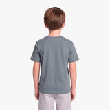 A child viewed from the back wearing a solid slate gray t-shirt and light gray pants