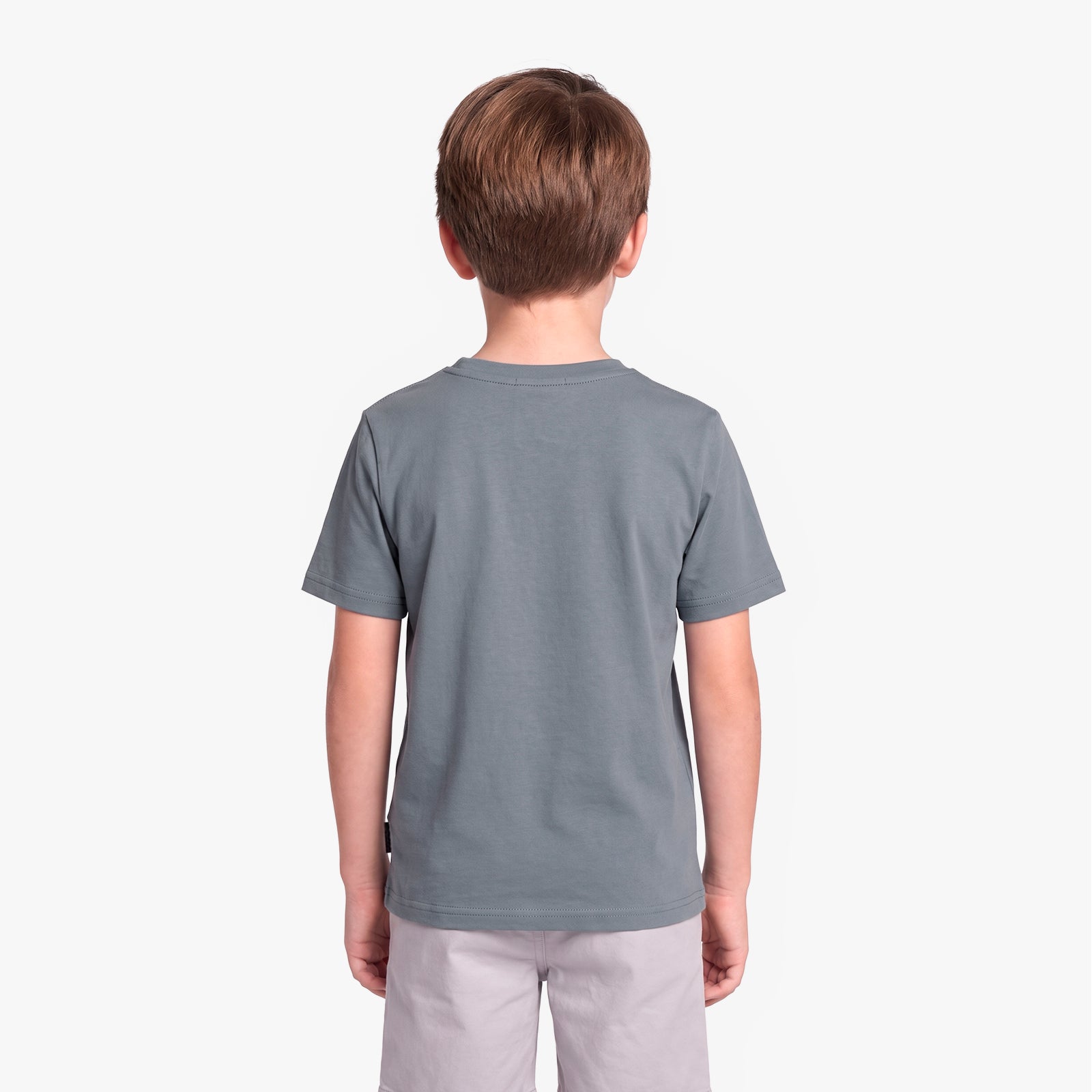 A child viewed from the back wearing a solid slate gray t-shirt and light gray pants