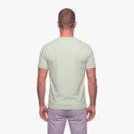 Man wearing a light green t-shirt on a white background